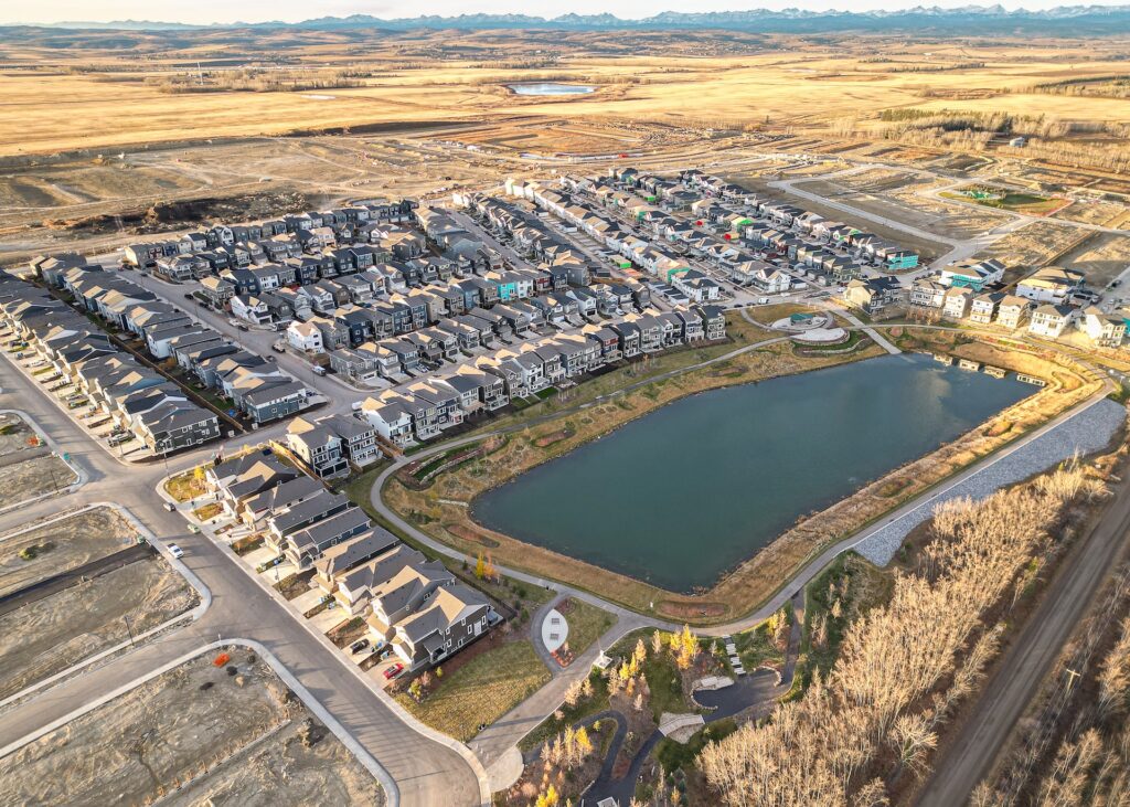 Aerial view of a Vermilion Hill neighborhood surrounding a pond with walking paths and landscaped green space.